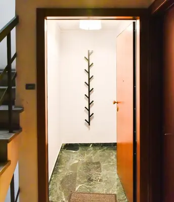 a hallway with a plant on the wall at 20 times Athens in Athens