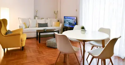 a living room with a couch and a table and chairs at 20 times Athens in Athens