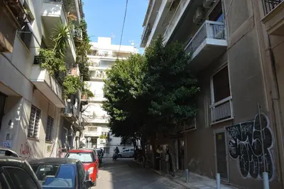a street with cars parked on the side of a building at 20 times Athens in Athens