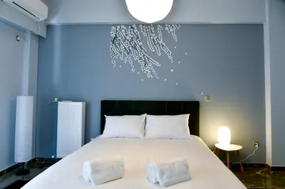 a bedroom with a large bed with two pillows at 20 times Athens in Athens