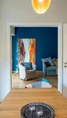 a blue room with a table and a couch at 24 times Athens in Athens