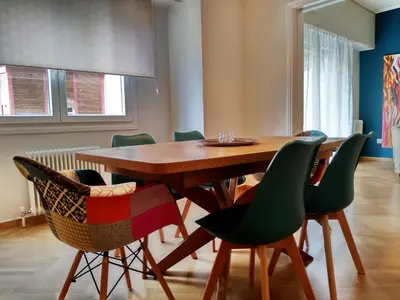 a dining room with a wooden table and chairs at 24 times Athens in Athens