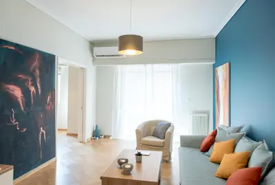 a living room with a couch and a chair at 24 times Athens in Athens