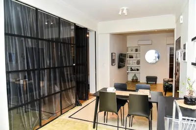 a dining room and living room with a table and chairs at Central apartment at Echarxia 2 beds for 5 pers by MPS in Athens