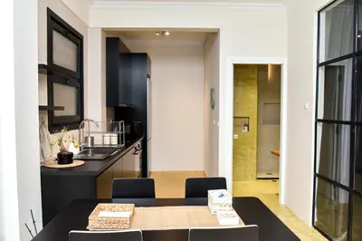 a kitchen and dining room with a table and chairs at Central apartment at Echarxia 2 beds for 5 pers by MPS in Athens