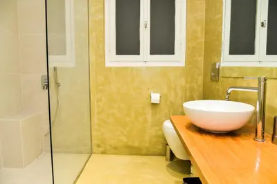 a bathroom with a sink and a toilet and a shower at Central apartment at Echarxia 2 beds for 5 pers by MPS in Athens