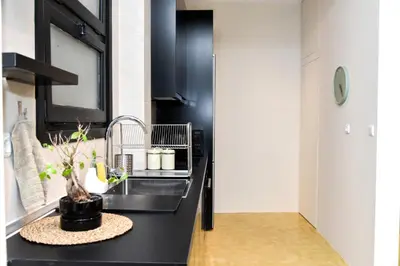 a kitchen with a black counter and a sink at Central apartment at Echarxia 2 beds for 5 pers by MPS in Athens