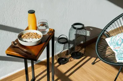 a table with a bowl of cereal and a bottle of orange juice at Môss Suite - Monastiraki Square View in Athens