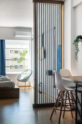a room with a sliding glass door with a table and chairs at Môss Suite - Monastiraki Square View in Athens