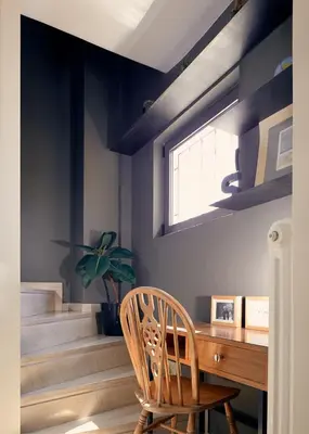 a wooden desk with a chair and a window at Two level apartment with panoramic view in Athens