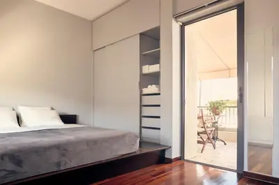 a bedroom with a bed and a large mirror at Two level apartment with panoramic view in Athens