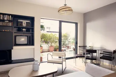 a living room with a tv and a table and chairs at Two level apartment with panoramic view in Athens