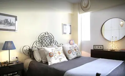 a bedroom with a bed with pillows and a mirror at Mets Area, Hip, Tasteful & Ultra Convenient Studio for 2 in Athens