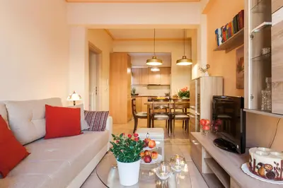 a living room with a couch and a table at Athens Casa Bonita in Athens