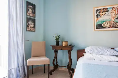 a bedroom with a bed and a table and a chair at Athens Casa Bonita in Athens