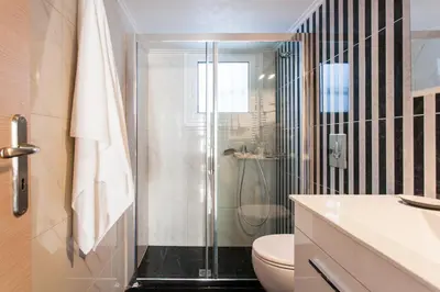 a bathroom with a shower and a toilet at Athens Casa Bonita in Athens