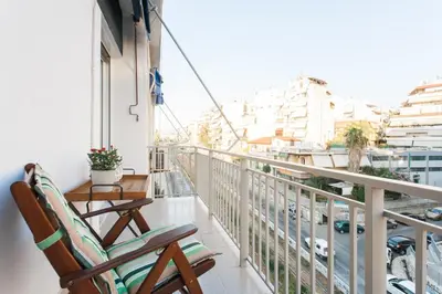 a balcony with chairs and a view of a city at Athens Casa Bonita in Athens