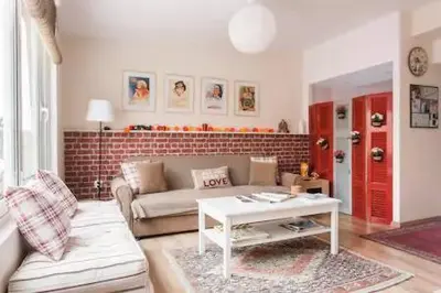 a living room with a couch and a table at LITTLE HOUSE ON THE ROOFTOP in Athens