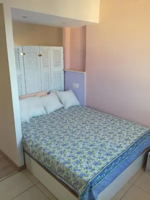 a small bedroom with a bed with white pillows at LITTLE HOUSE ON THE ROOFTOP in Athens