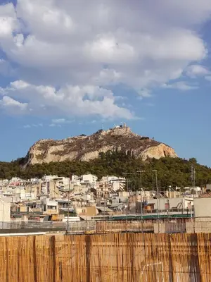 a view of a city with a mountain in the background at LITTLE HOUSE ON THE ROOFTOP in Athens