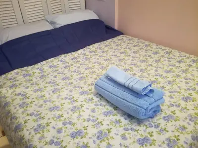 a bed with blue towels sitting on top of it at LITTLE HOUSE ON THE ROOFTOP in Athens