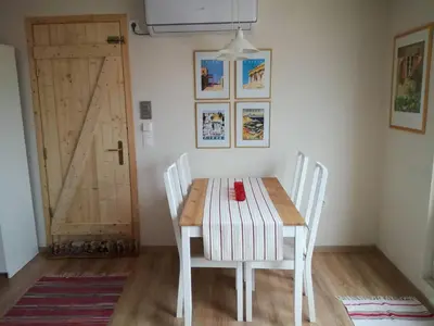 a dining room with a table and chairs and a door at LITTLE HOUSE ON THE ROOFTOP in Athens