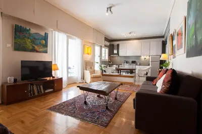 a living room with a couch and a table at 2 Bedroom Artist's Apartment - So Athens in Athens