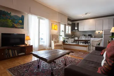 a living room with a couch and a table at 2 Bedroom Artist's Apartment - So Athens in Athens