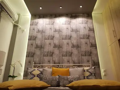 a room with a bed with a wall at Golden Aurora - Modern Apartment in Egaleo-Athens in Athens