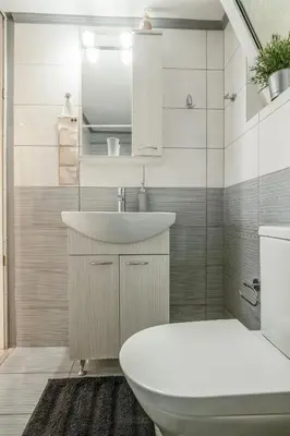a bathroom with a sink and a toilet at Golden Aurora - Modern Apartment in Egaleo-Athens in Athens