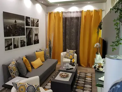 a living room with a gray couch and yellow pillows at Golden Aurora - Modern Apartment in Egaleo-Athens in Athens