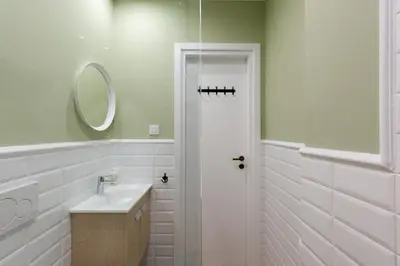 a white bathroom with a sink and a mirror at Dinostratus House - Boutique Studios in Athens