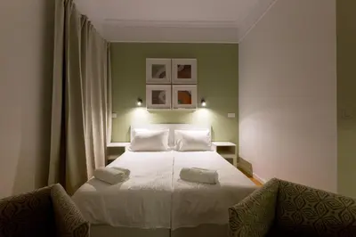 a bedroom with a bed with two white pillows at Dinostratus House - Boutique Studios in Athens