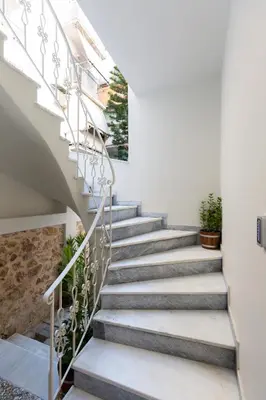a staircase in a house with white walls at Dinostratus House - Boutique Studios in Athens