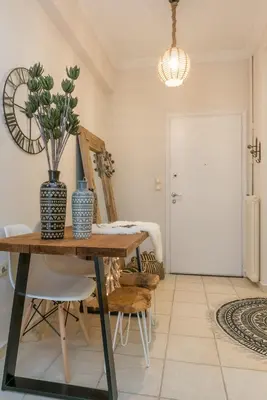 a dining room with a table and a potted plant at Acropolis, Urban Lifestyle apartment in Athens