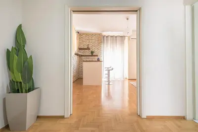 a hallway with a potted plant in a white room at Acropolis View in Athens