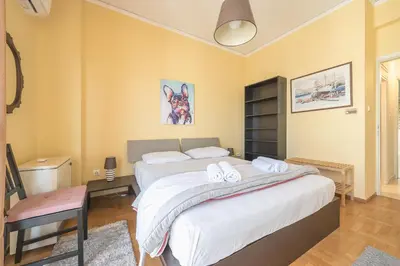 a bedroom with a large bed with towels on it at Acropolis View in Athens
