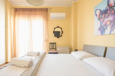 a bedroom with two beds and a window at Acropolis View in Athens