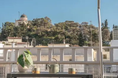 a balcony with a table with a plant on it at Acropolis View in Athens