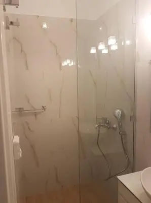 a shower with a glass door in a bathroom at NN Luxury Room near Athens Airport in Spáta