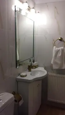 a white bathroom with a sink and a mirror at NN Luxury Room near Athens Airport in Spáta