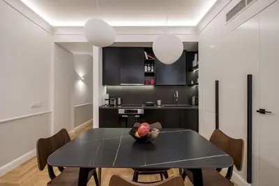 a kitchen and dining room with a black table and chairs at Chic central Athens apartment at Mavilli Sq. in Athens