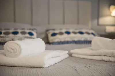 a pile of towels sitting on top of a bed at Chic central Athens apartment at Mavilli Sq. in Athens