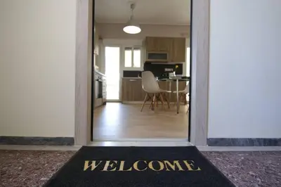 a welcome mat in a room with a kitchen at Penthouse lux flat with 2 bd next to larissis in Athens
