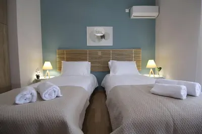 two beds with towels on them in a room at Penthouse lux flat with 2 bd next to larissis in Athens