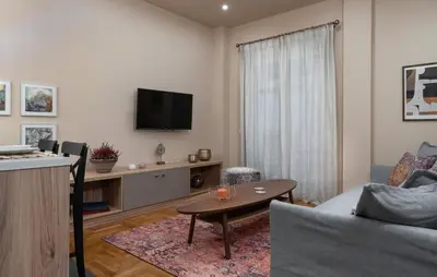 a living room with a couch and a table at Absolute Athens v in Athens