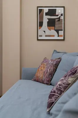 a blue couch with two pillows in a bedroom at Absolute Athens v in Athens