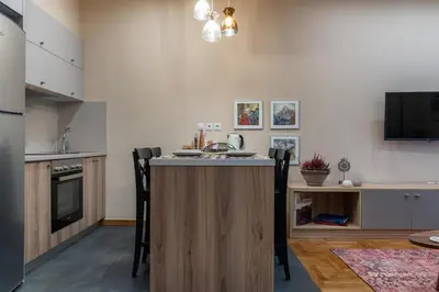 a kitchen with a island in the middle of a room at Absolute Athens v in Athens
