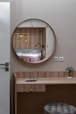 a mirror on a wall above a desk in a room at Absolute Athens v in Athens
