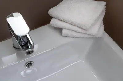 a pile of towels sitting on top of a bathroom sink at Absolute Athens v in Athens